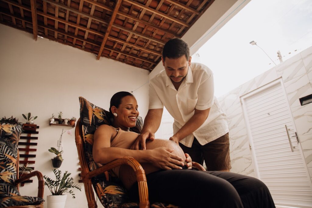a man standing over a woman who is sitting in a chair